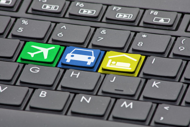 Keyboard with keys to book flight, rental car and hotel - online booking concept